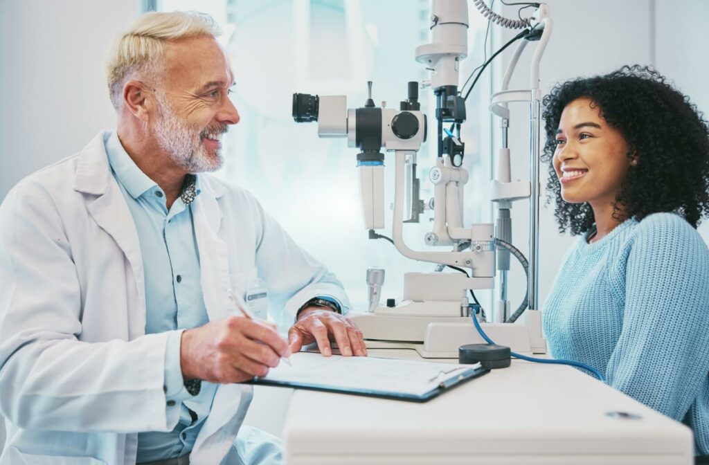 A young woman gives a health history to her optometrist before she gets a comprehensive eye exam.