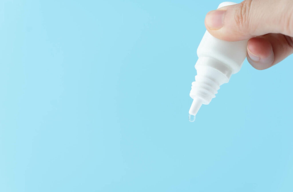 Artificial tears to treat dry eye on a blue background.