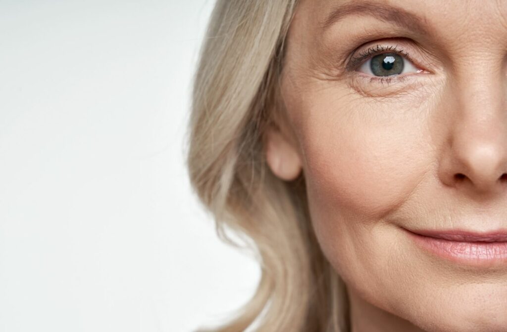 A close-up of a woman happy after healing from LASIK surgery & experiencing improved vision without glasses.