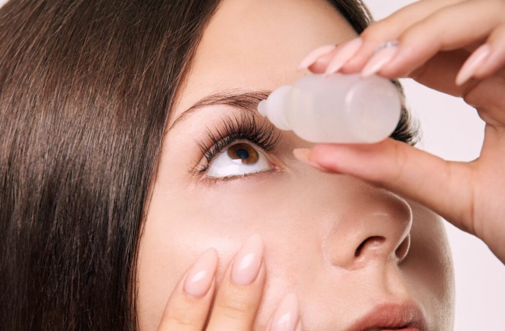 A close-up of a woman using prescribed eye drops to prevent infection following her LASIK surgery