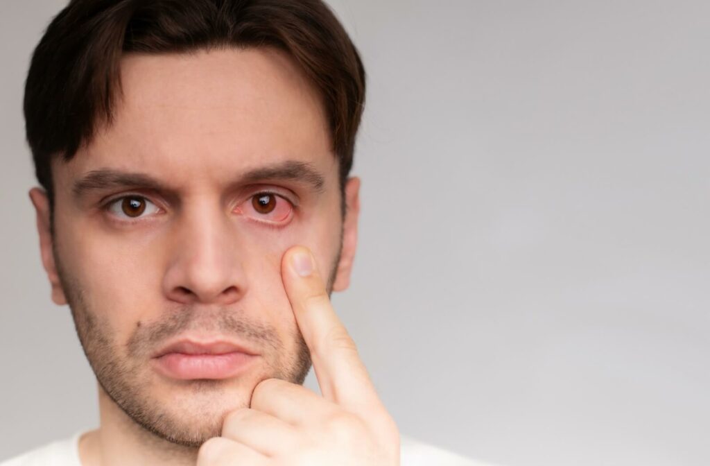 A close-up image of a woman placing a contact lens into her eye.