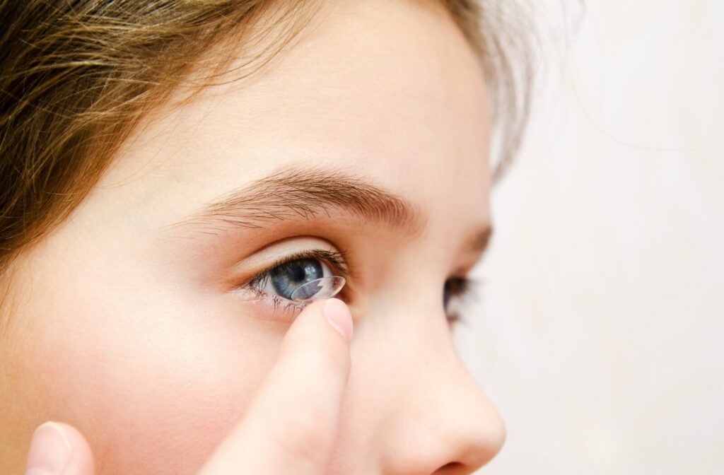 Close-up of a child's eye as they insert a contact lens.