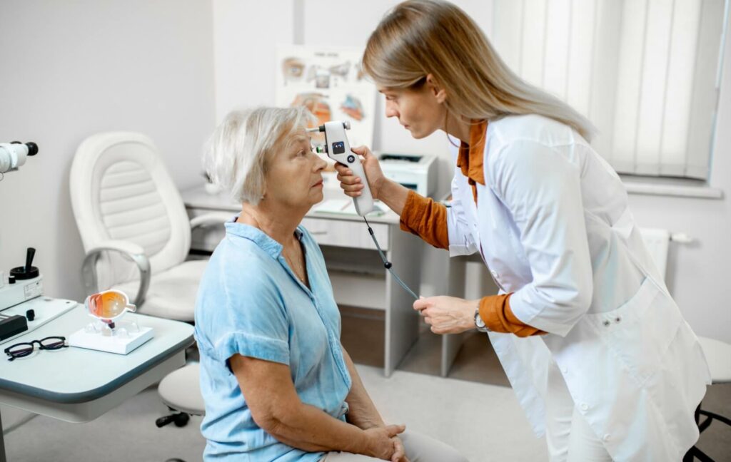 An ophthalmologist uses a tonometer to measure their patient's eye pressure to test for glaucoma.