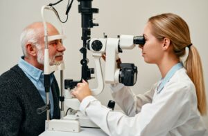 An older adult gets an comprehensive eye exam so their eye doctor can look for signs of glaucoma and cataracts for timely intervention.