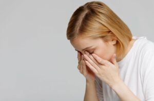 A person feels worsening dry eye symptoms from their contact lenses.