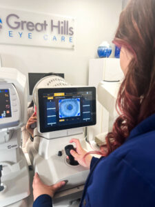 A patient getting theirs eyes examined by an optometrist.