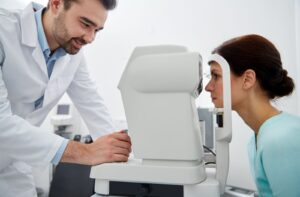 Patient receiving eye pressure test to detect early signs of glaucoma.