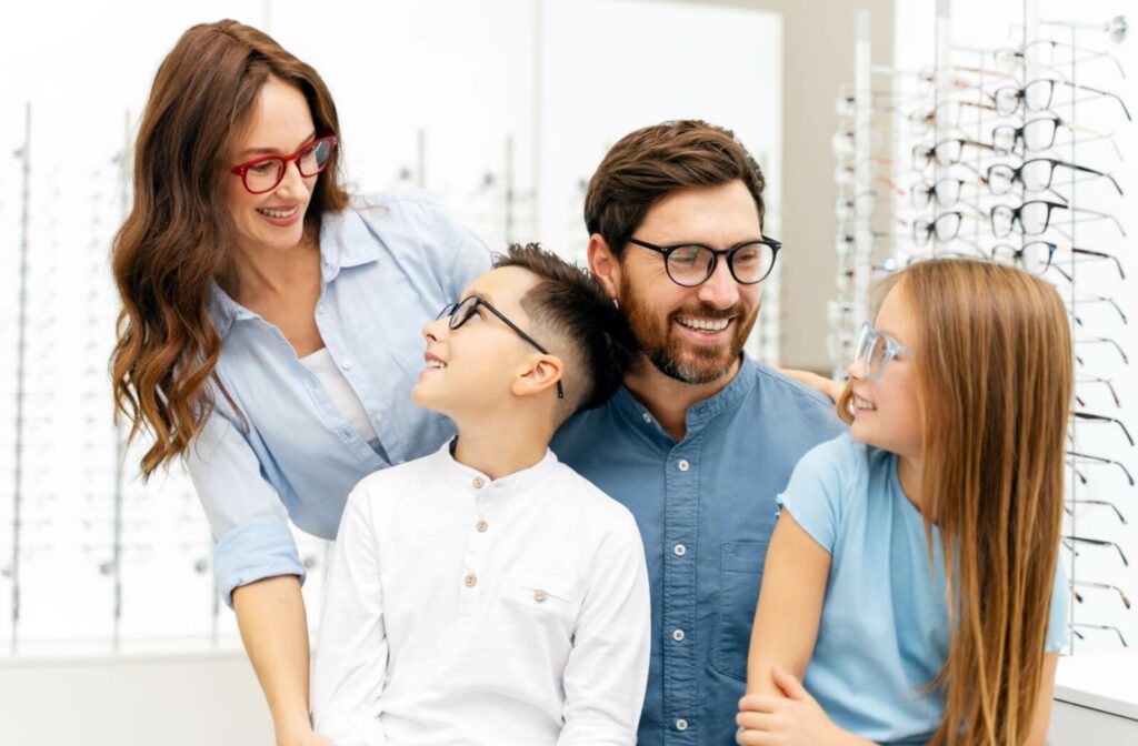 Family wearing prescription eyeglasses while shopping at an optical store.