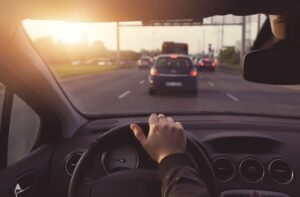 Sun glare impacting vision while driving in traffic.