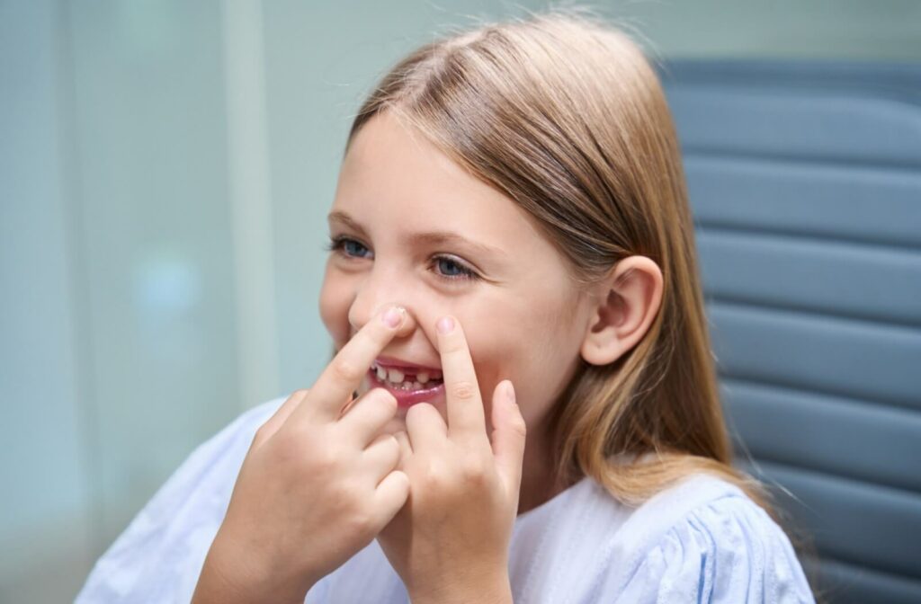 Young child pointing to eyes in clinic
