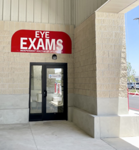Great Hills Eye Care storefront entrance with an “Eye Exams” sign above the door, featuring the clinic’s logo on the glass door.